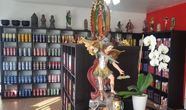 store interior with candles and saints